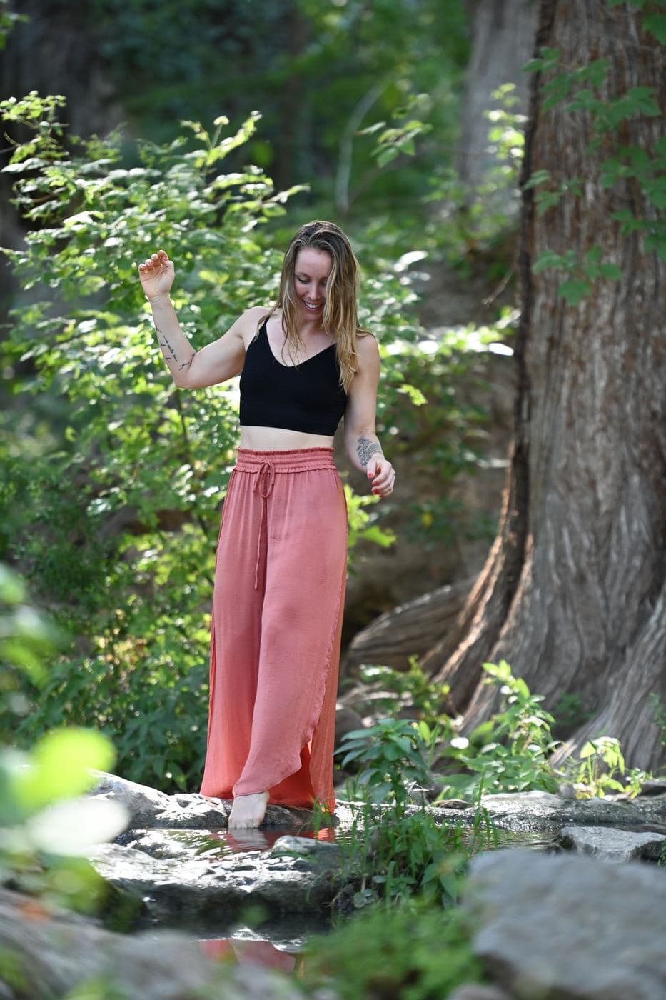 Madeleine dipping her toe into a creek