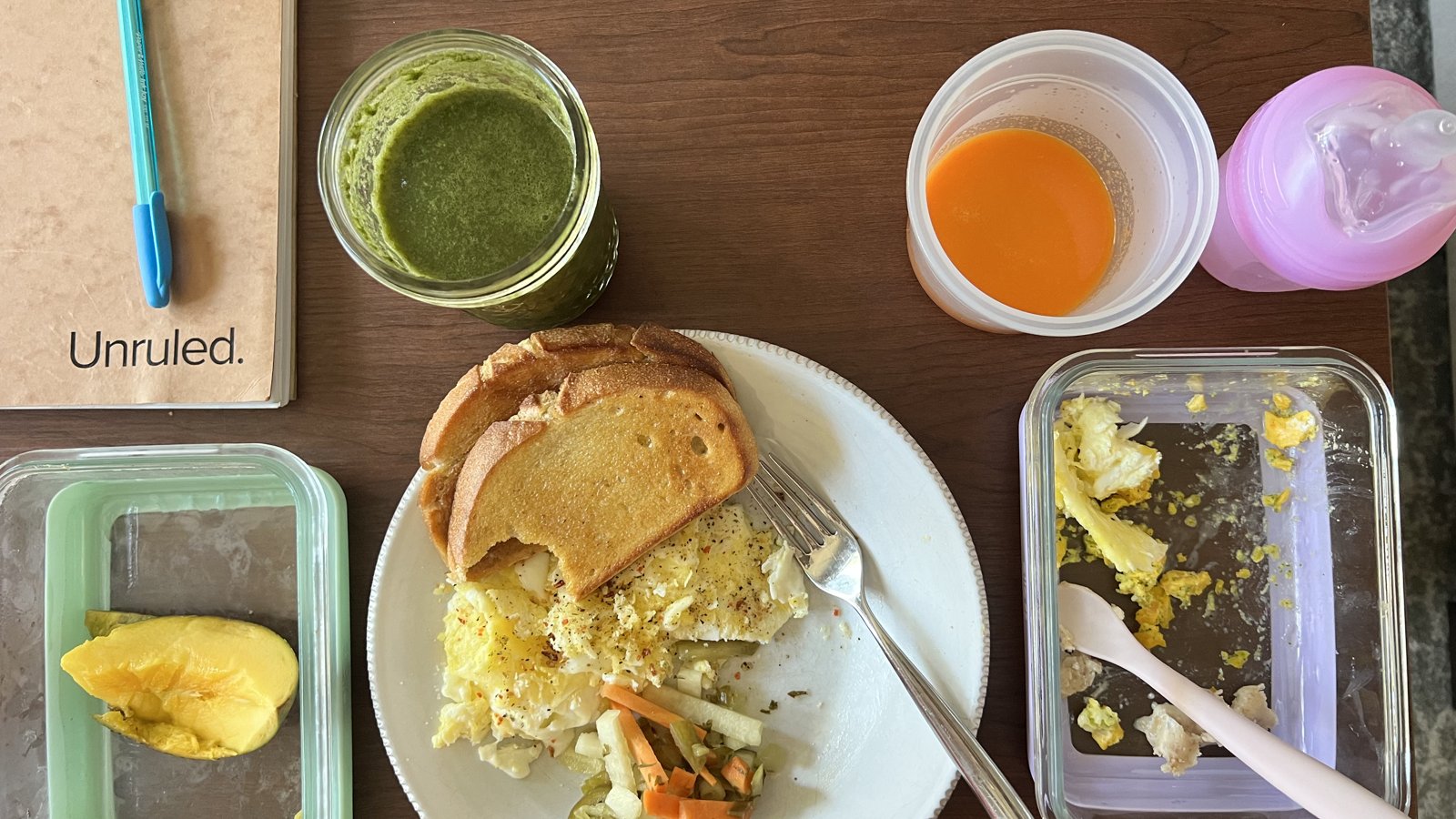 A real breakfast table -- a green smoothie, eggs on sourdough toast with vegetables, and a carrot ginger shot